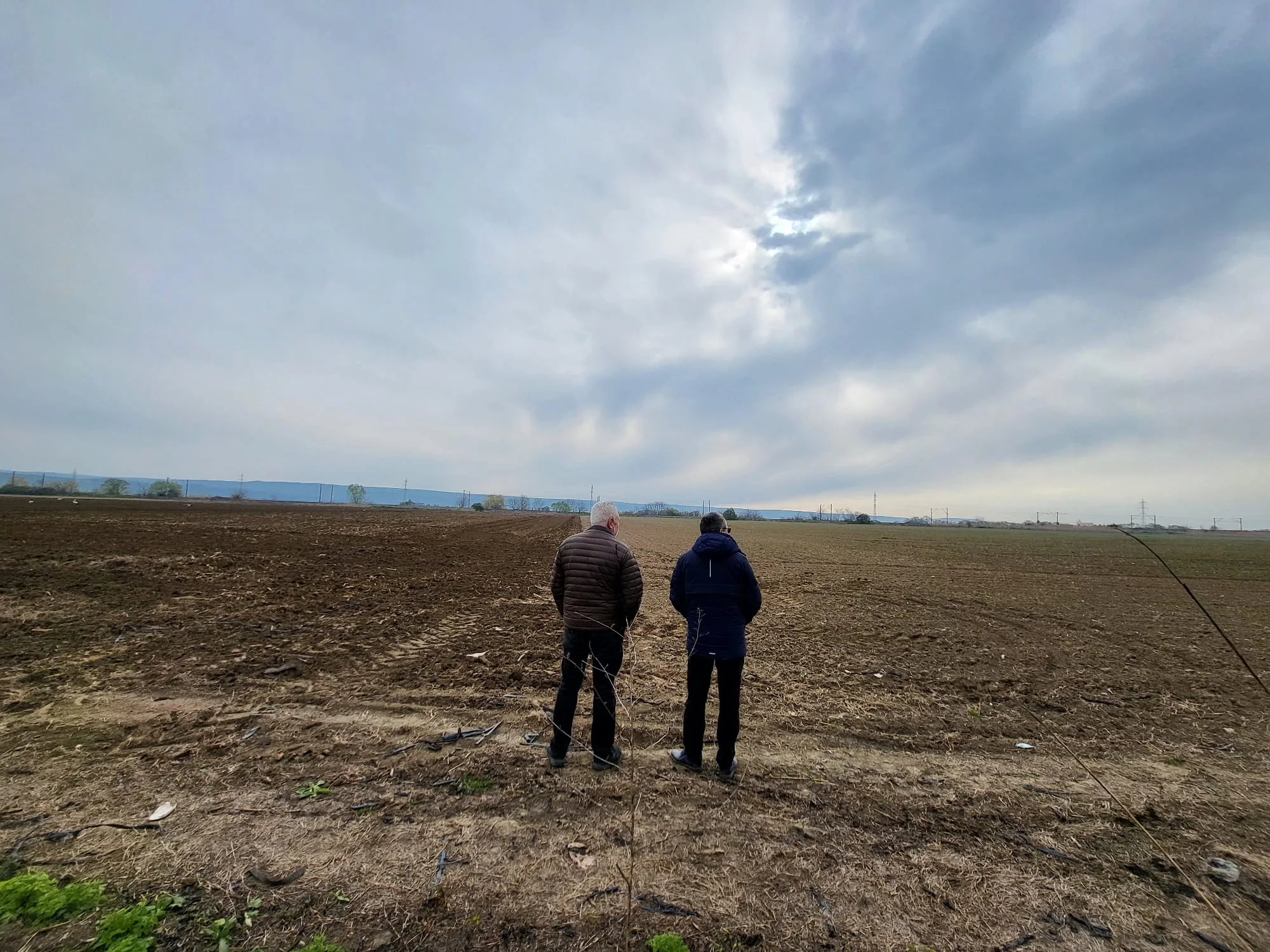 Alexandru Vulpe and Adelin Morarasu looking across the Orbeni field